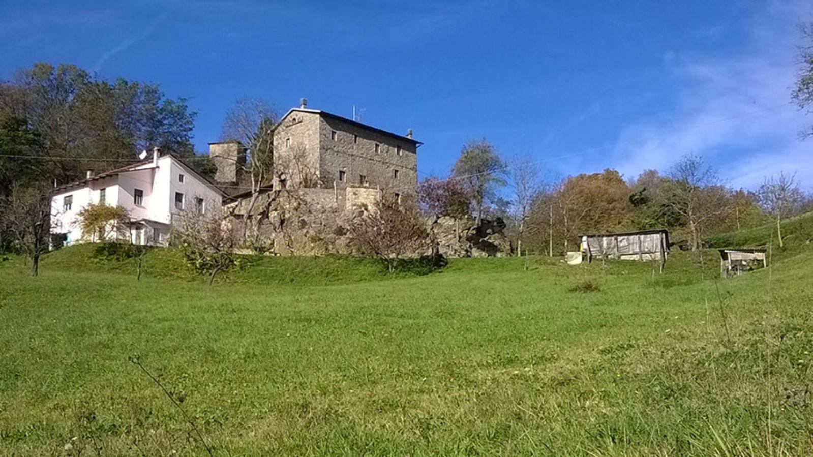 Rocca di Roffeno - case medievali con prato verde in primo piano